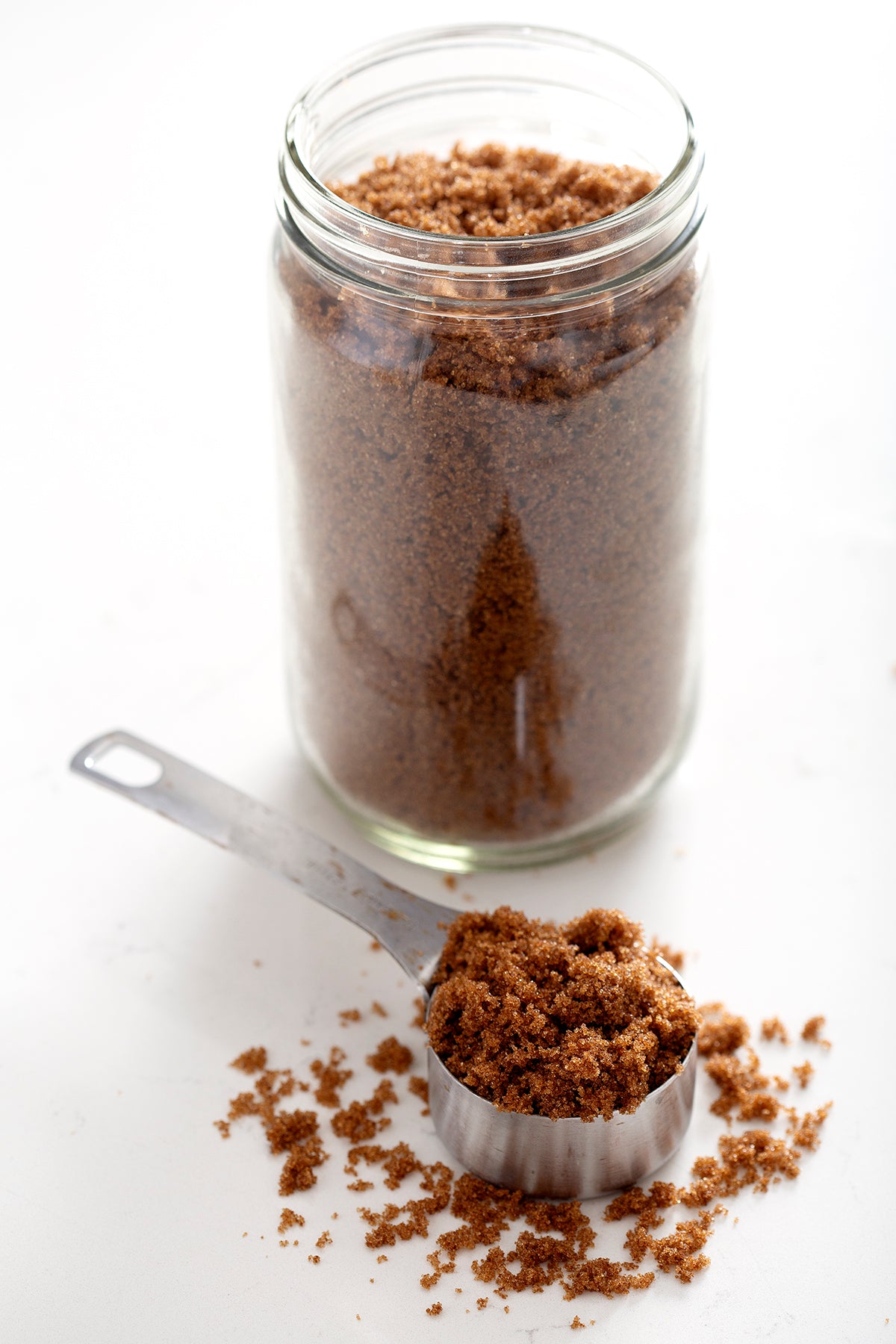 jar and measuring cup of brown sugar