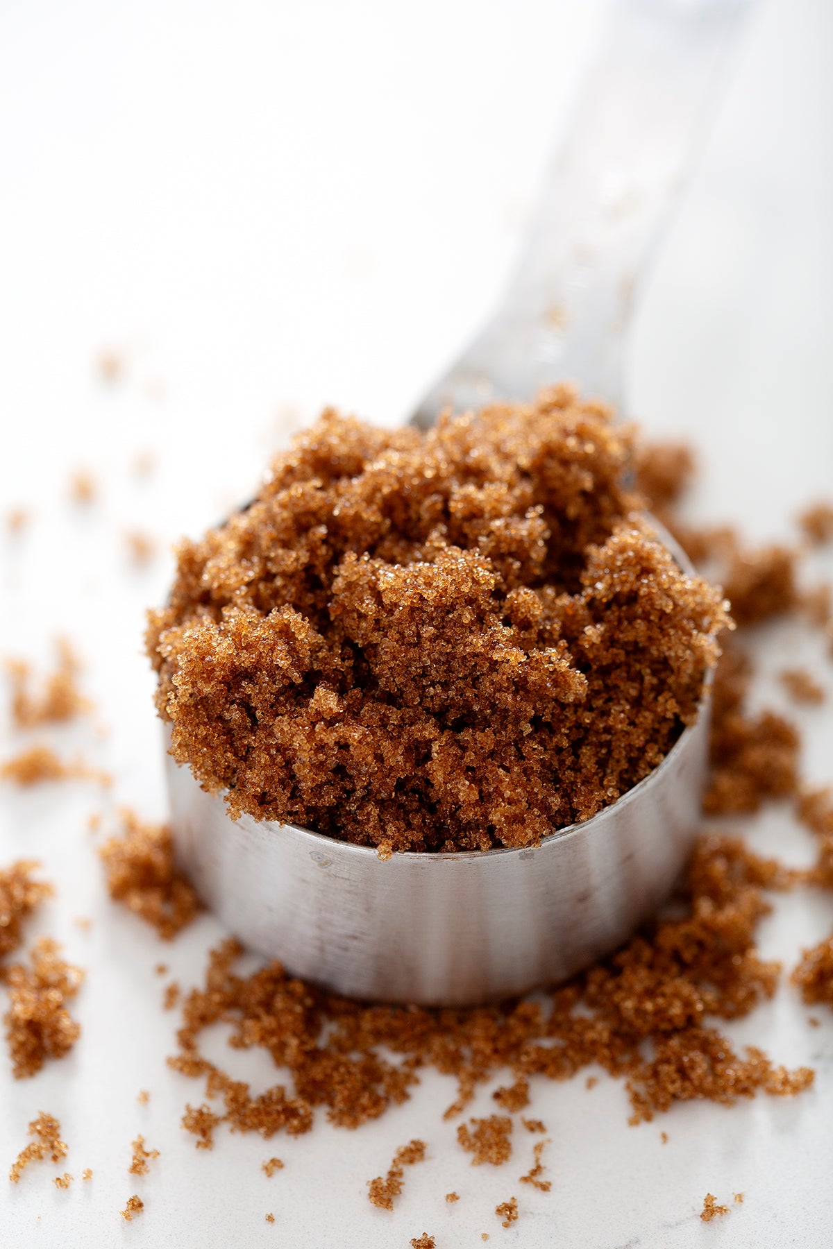 measuring cup overflowing with brown sugar