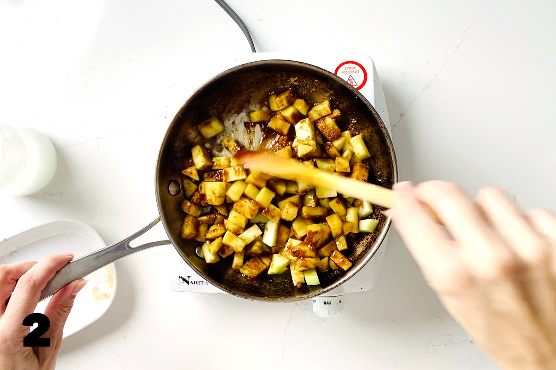 sautéing apple in skillet while stirring