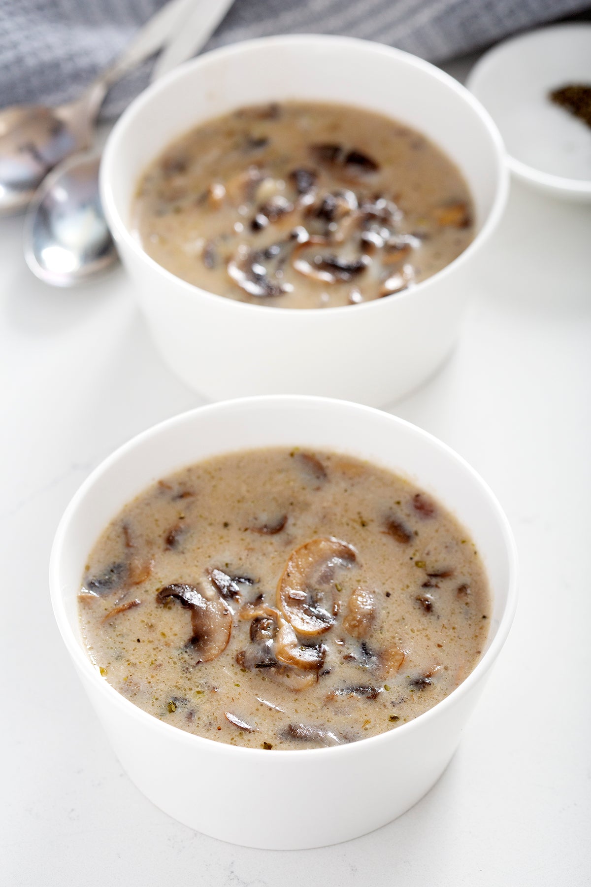 two white bowls of gluten free cream of mushroom soup