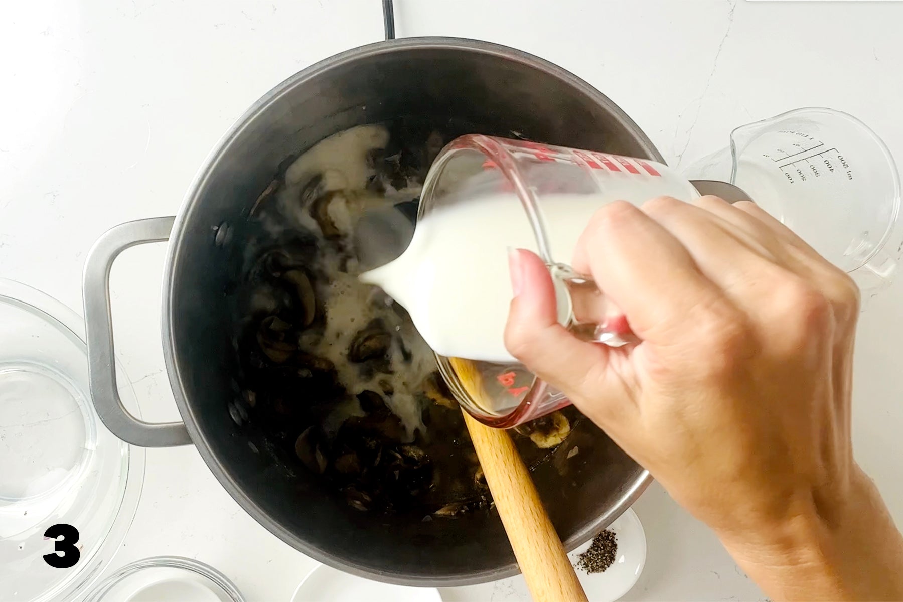 pouring milk into stock pot