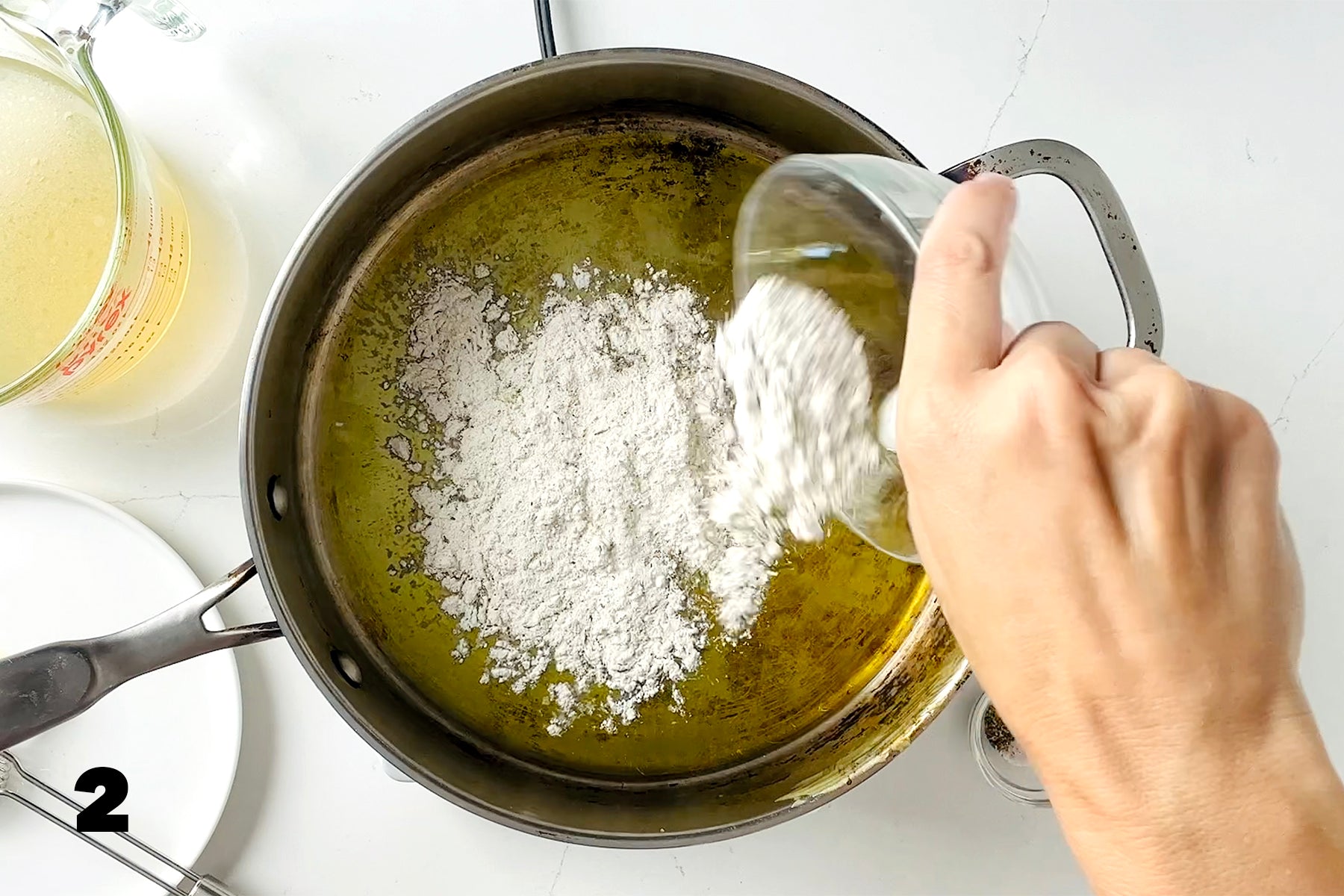 adding flour to frying pan