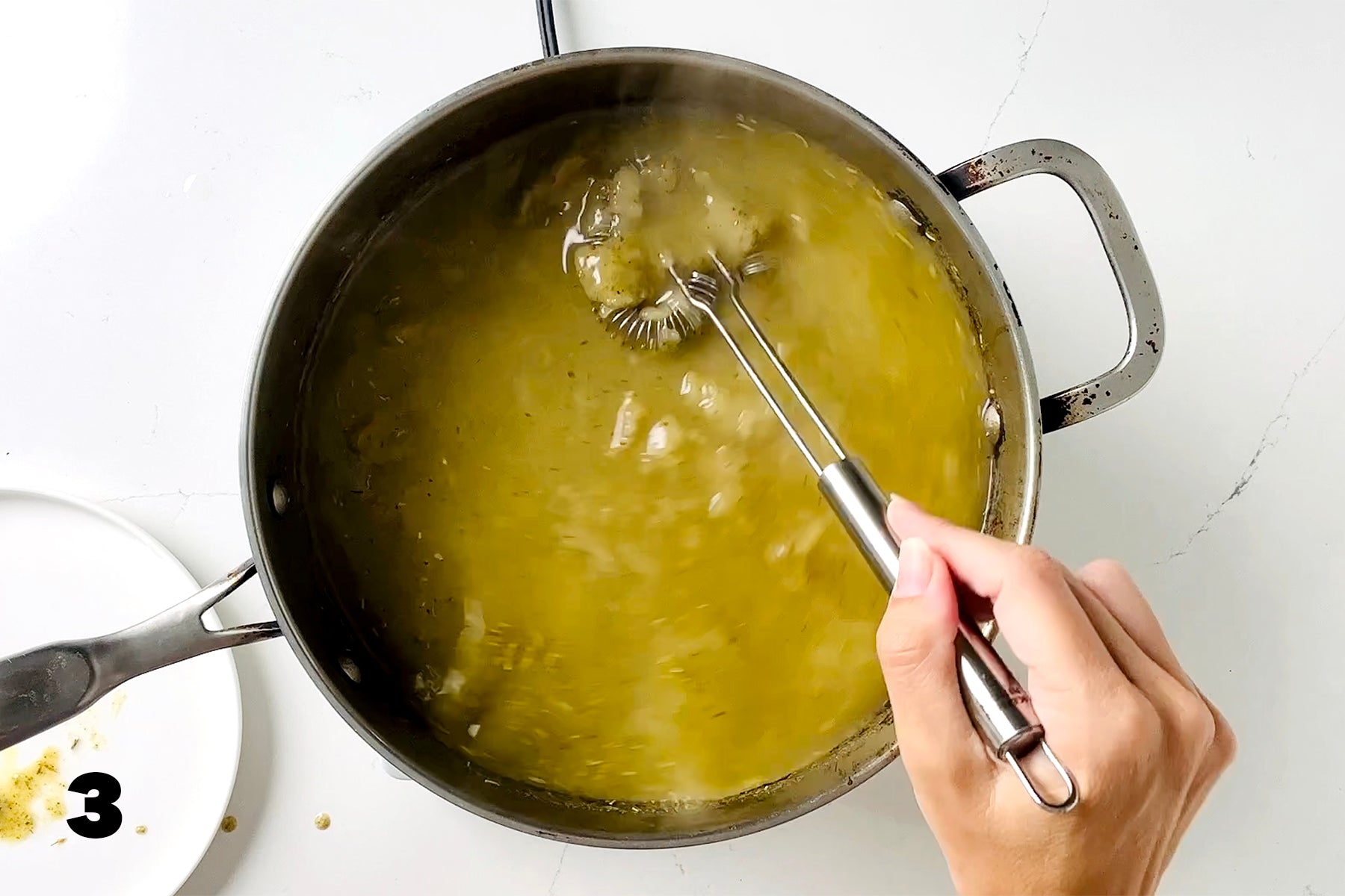 whisking gravy in frying pan