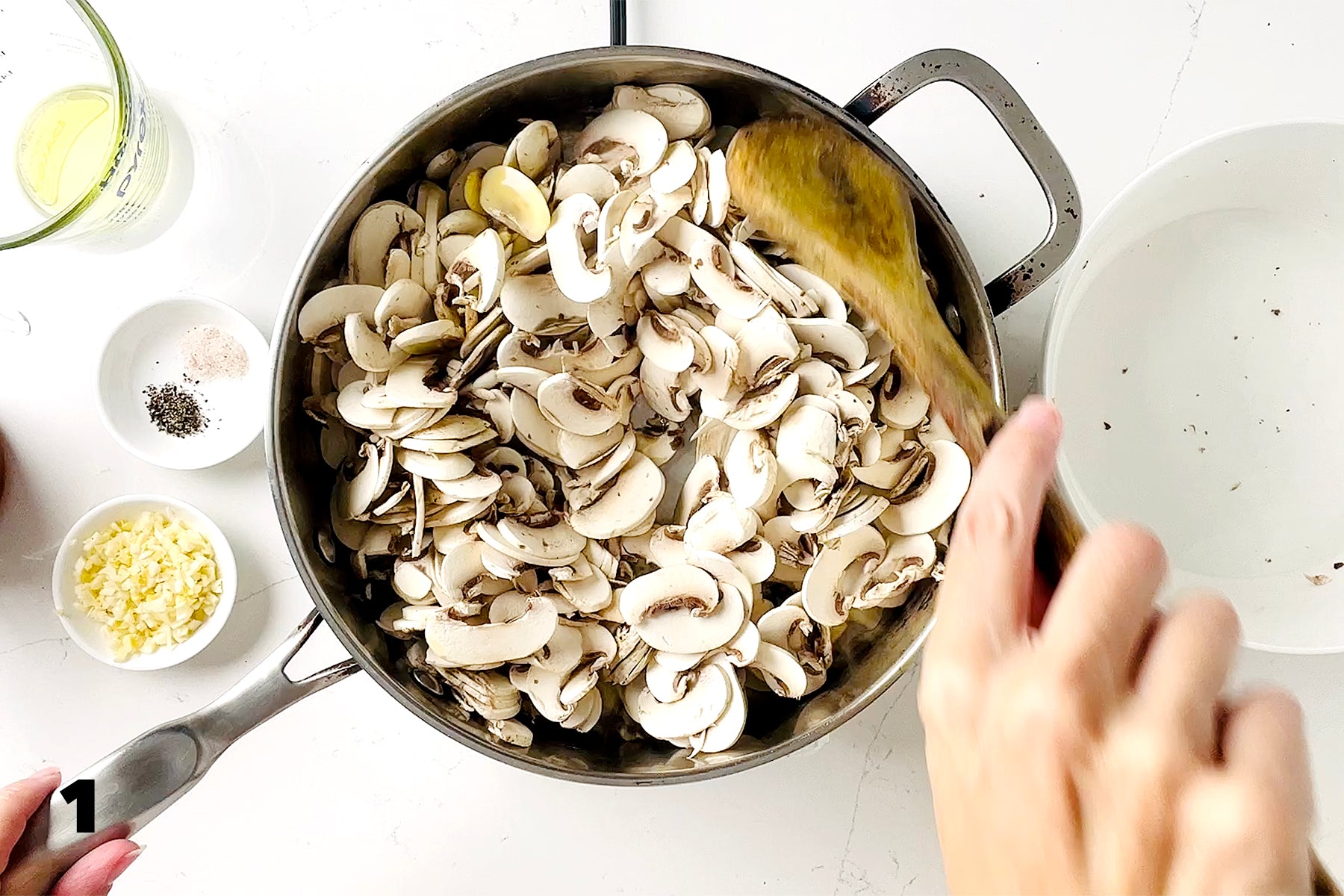 stirring mushrooms in saute pan