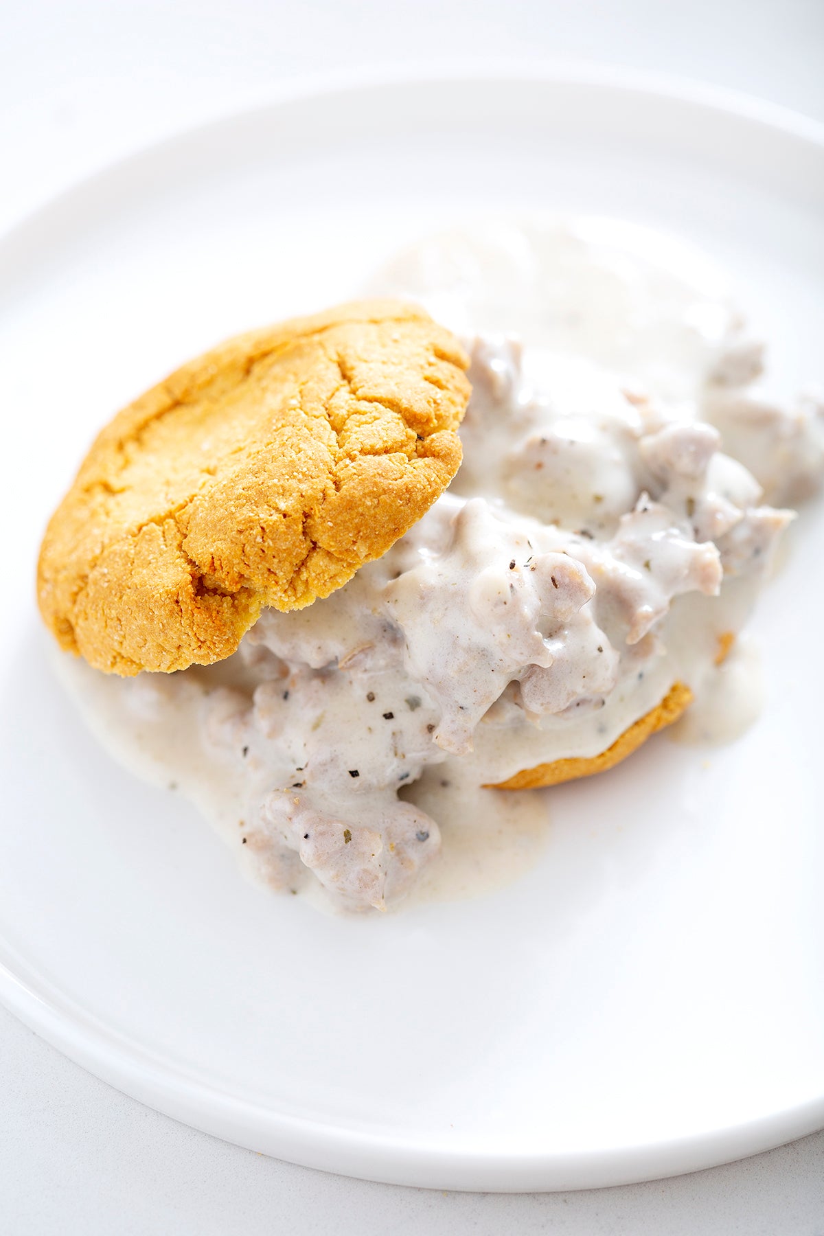 gluten free biscuits and sausage gravy on white plate