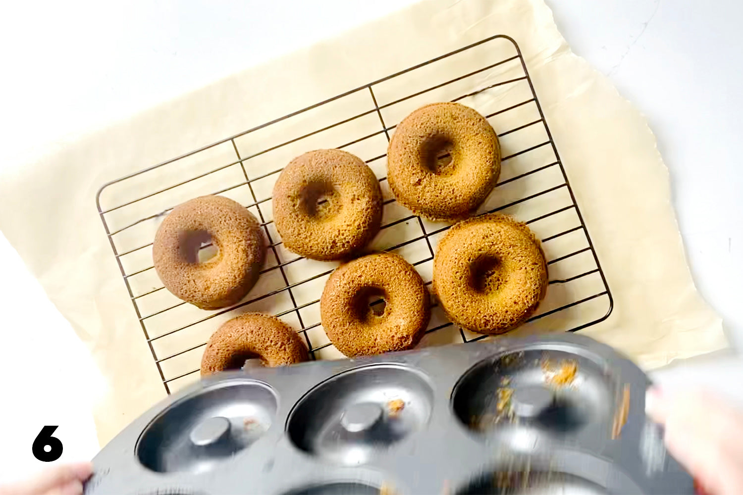 placing baked donuts on wire rack