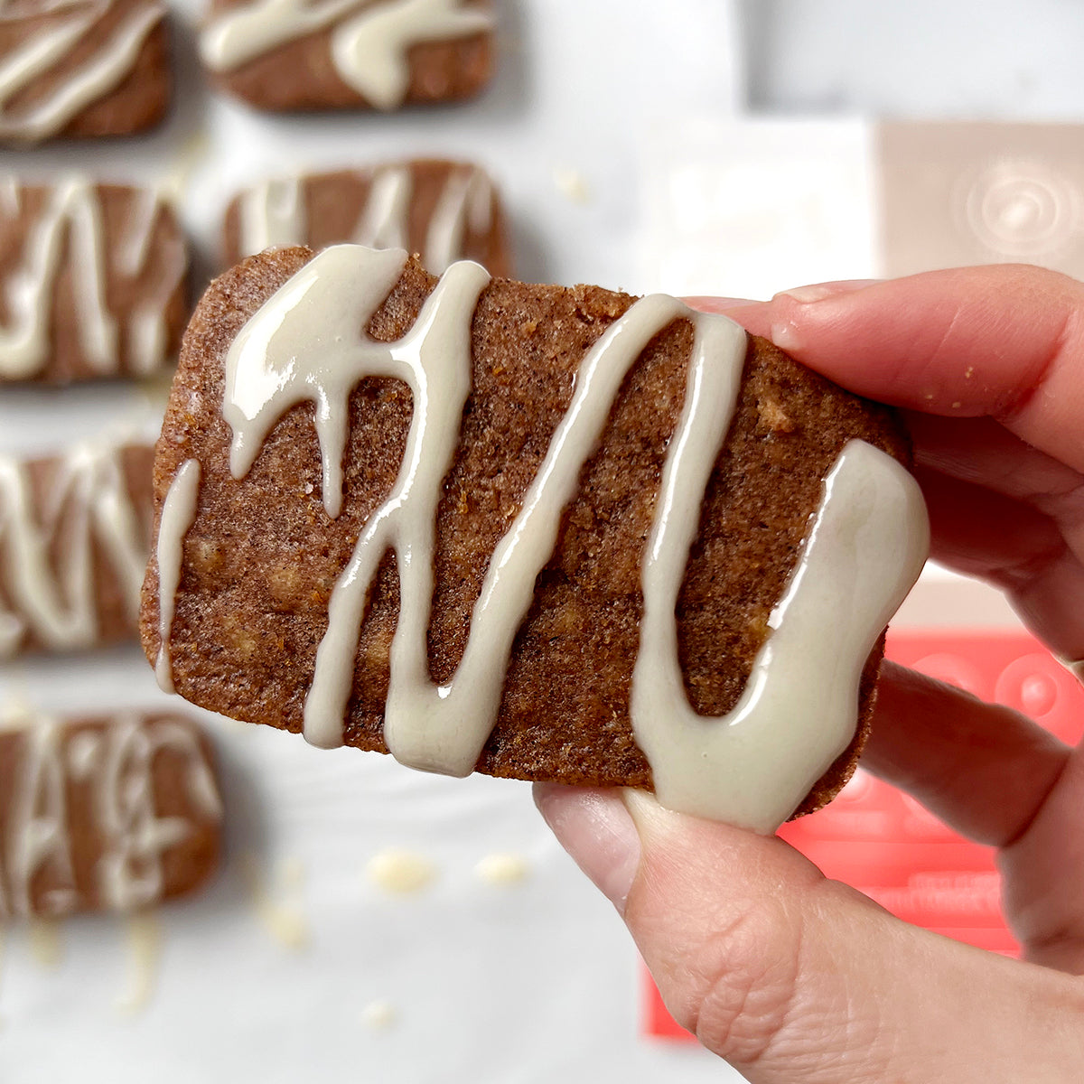 hand holding glazed cinnamon cake bars