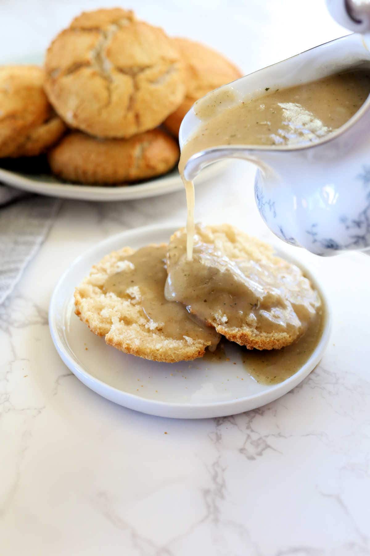 pouring gravy over biscuits