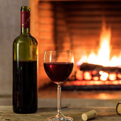 Bottle of red in front of fire