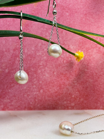 Pearl chain drop earrings with sterling silver details. Single pearl bead necklace with sterling silver chain.