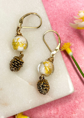 Gold pinecone earrings with white and 14k gold foil glass ball drop earrings with brass details.