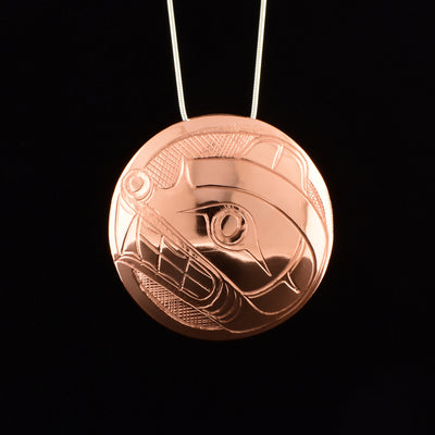 Round copper bear pendant hand-carved by Kwakwaka'wakw artist Norman Seaweed. Pendant is domed and has hidden bail on back. Pendant measures 2" in diameter. Chain not included.