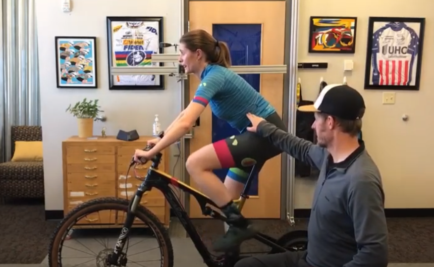 bike fitter shows how correct hip rotation on a bike will activate core