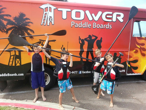 group of kids standing in front of the Tower truck