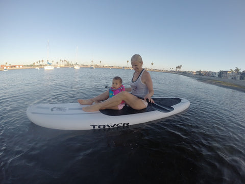 mom and baby on a paddle board