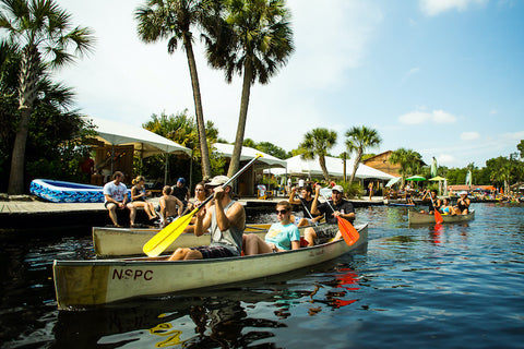 group of people riding canoes