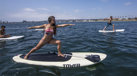 women doing yoga on paddle boards