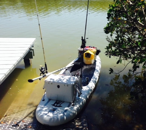 paddle board with fishing supplies loaded on