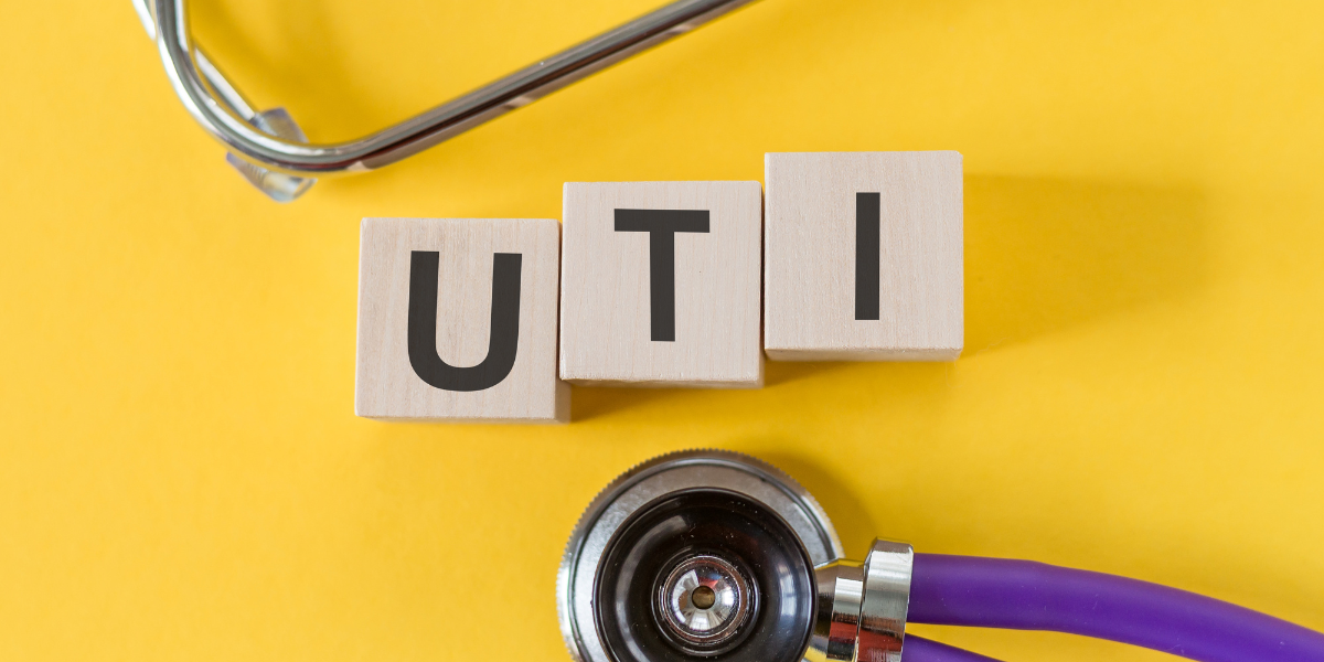 Urinary Tract Infection - Yellow background with stethoscopes and the letters UTI