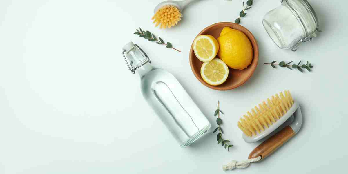 Set of eco-friendly cleaning tools with vinegar, baking soda, and lemons for maintaining a safe, clean, and fresh-smelling cat litter box.