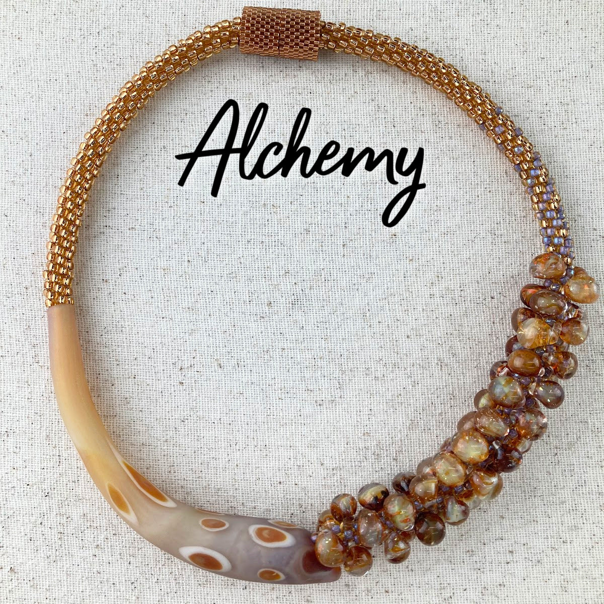 Alchemy beaded kumihimo necklace featuring topaz colored seed beads, Unicorne crescent beads, Unicorne teardrop beads, and peyote stitch endcap covers.