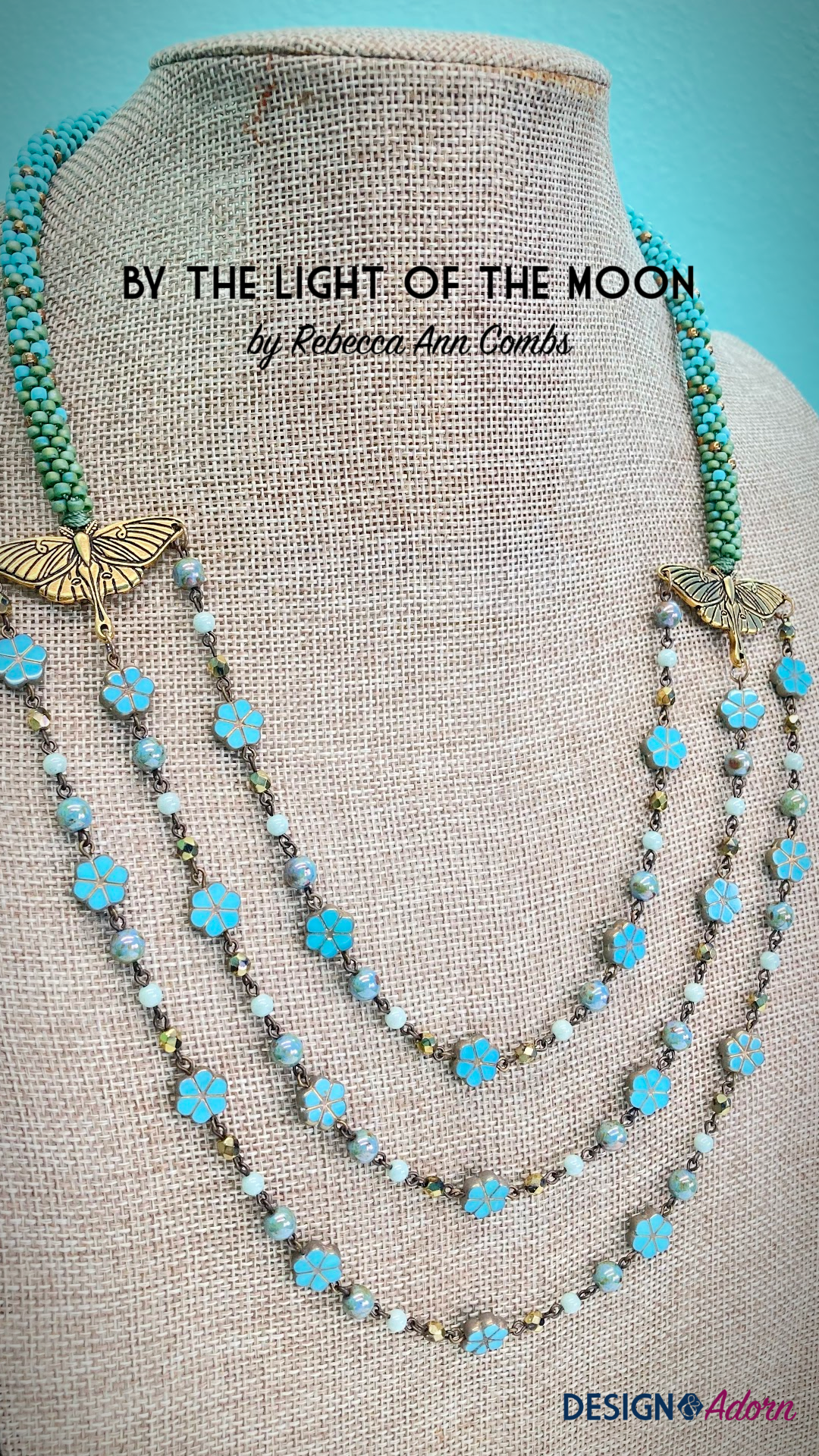 Three strands of Czech glass beads on chain joined by TierraCast luna moth pendants.  Beaded kumihimo ropes extend from the moths to finish the necklace.