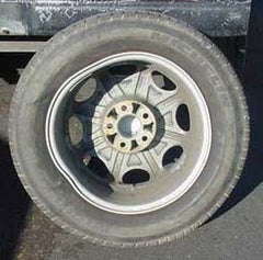 Pictured: damaged Michelin tire and wheel set after off-roading