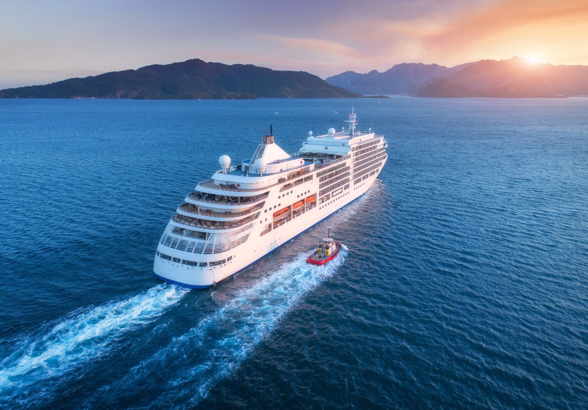 Birds's eye view of cruise ship heading towards the horizon