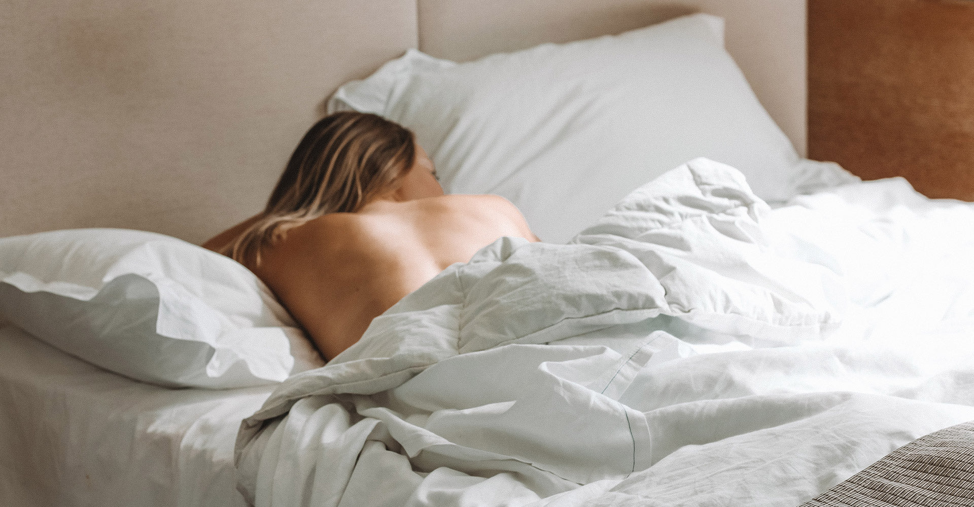 Woman's bare back while morning light shows