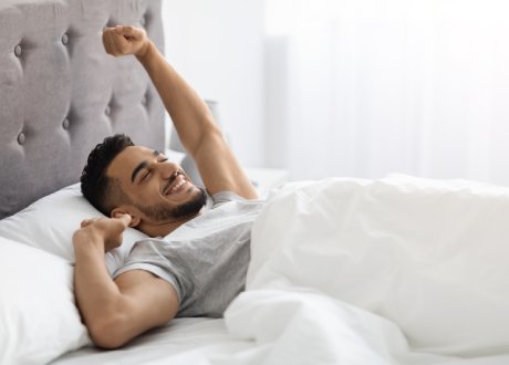 a guy waking up happily