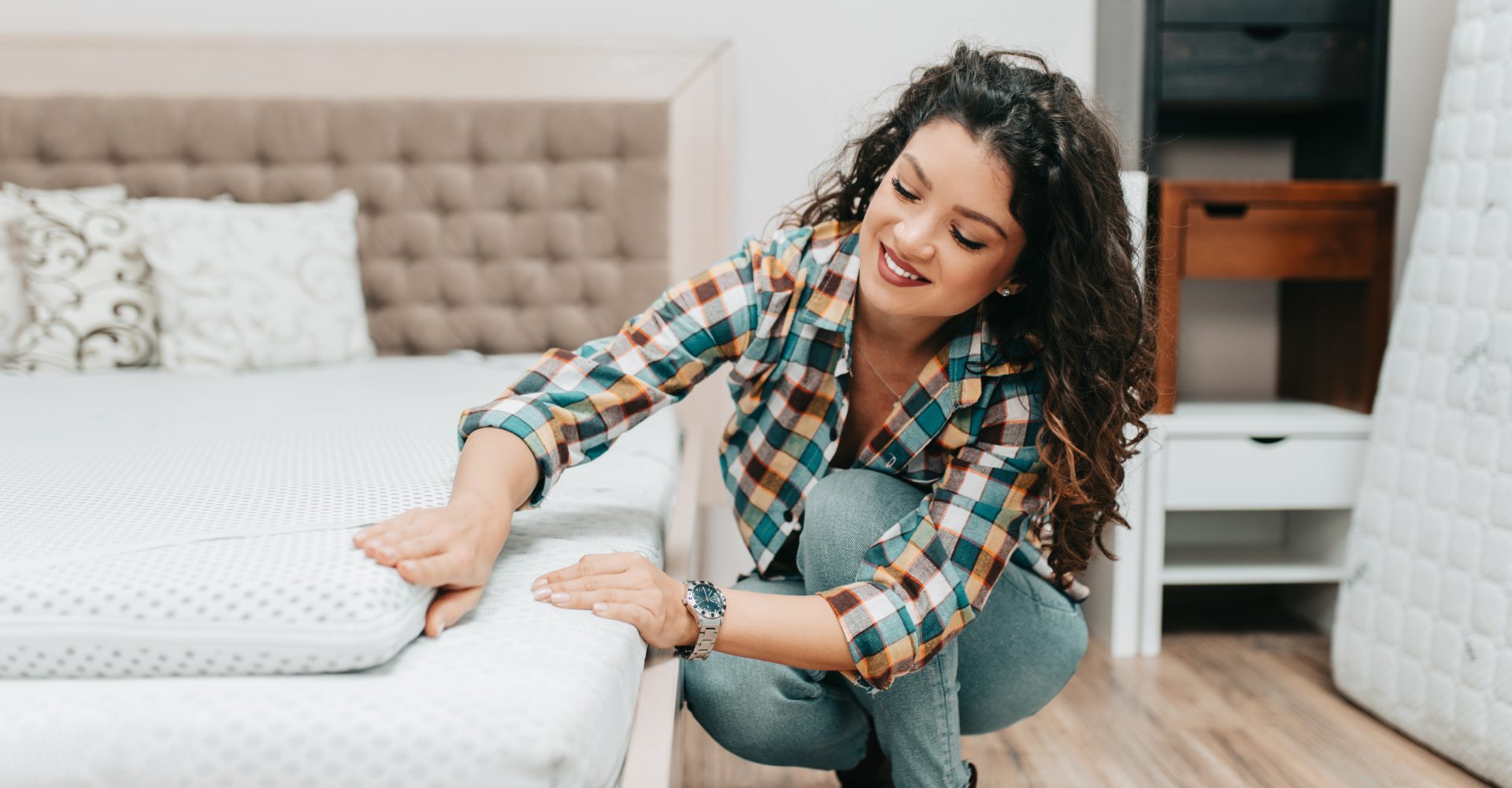 a woman checking the mattress