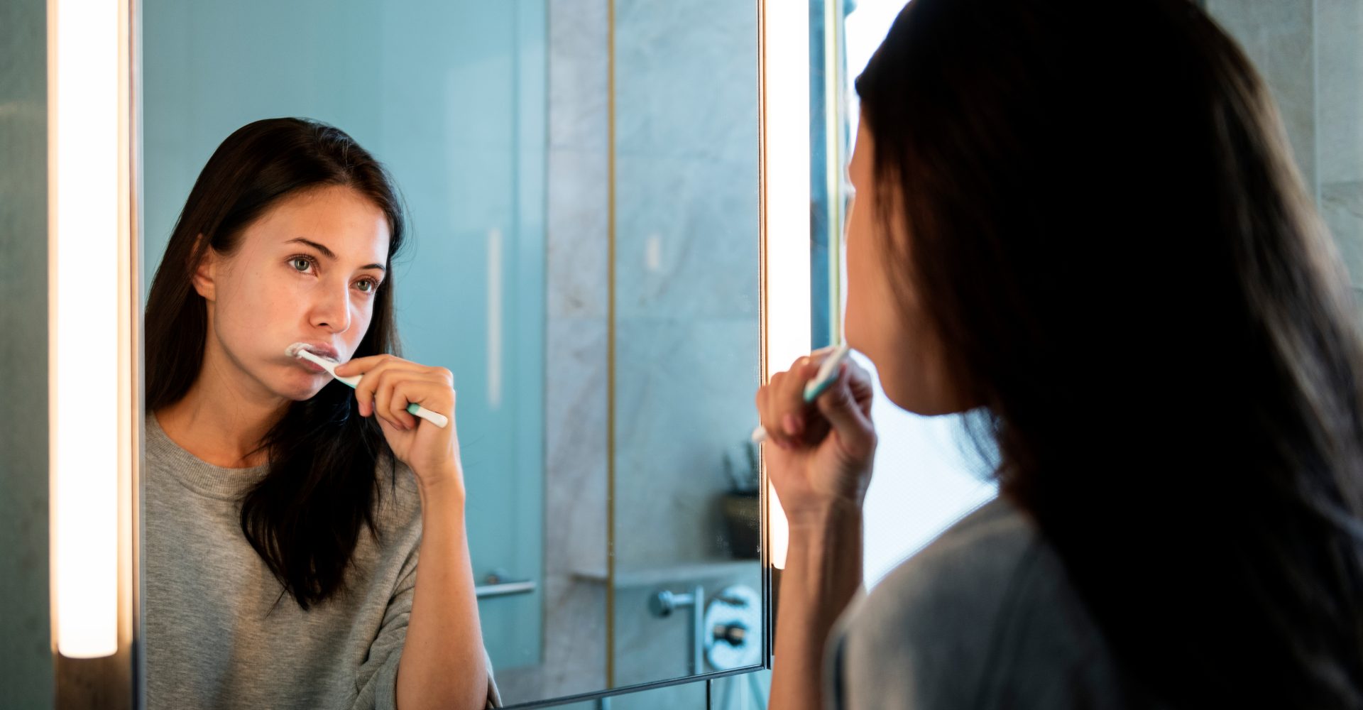 a woman brushing her teeth