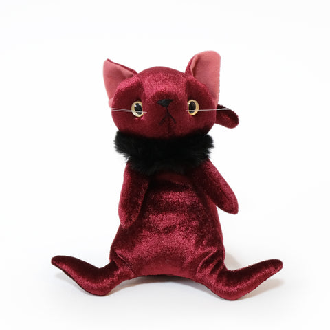 A stylish stuffed cat with a stylish fur around its neck. The color is wine red.