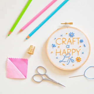Craft a Happy Life in 4-inch hoop with fabric and scissors around it