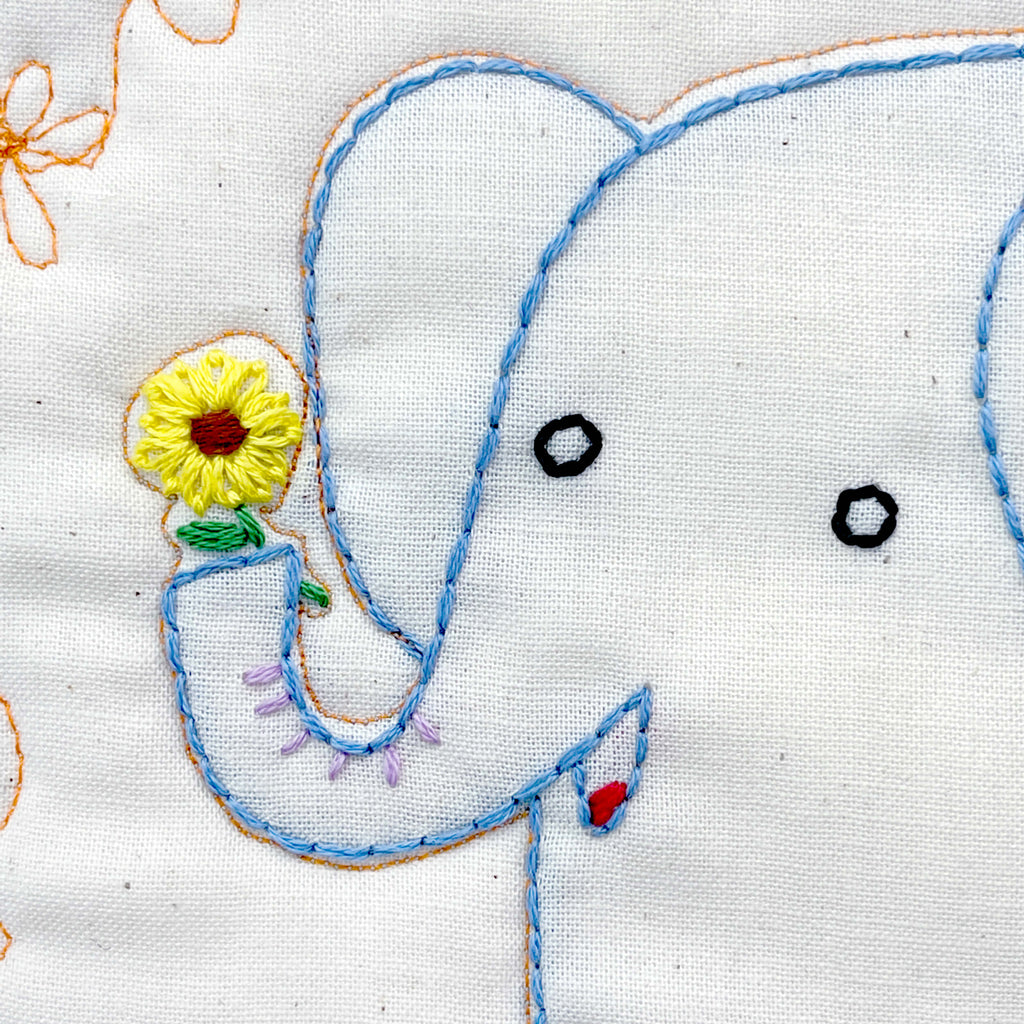 Elephant embroidery holding a small sunflower