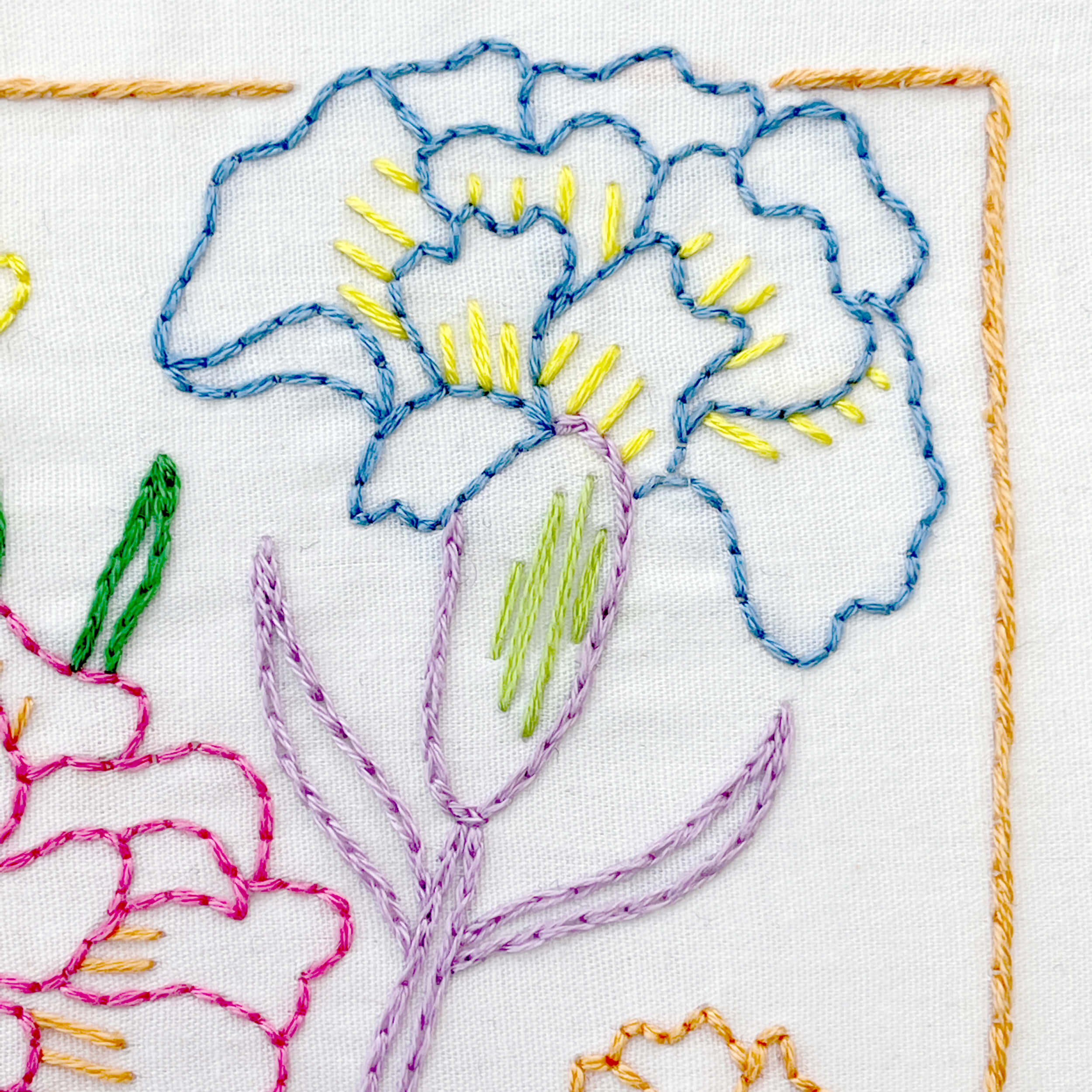 blue carnation flower embroidered with a purple stem