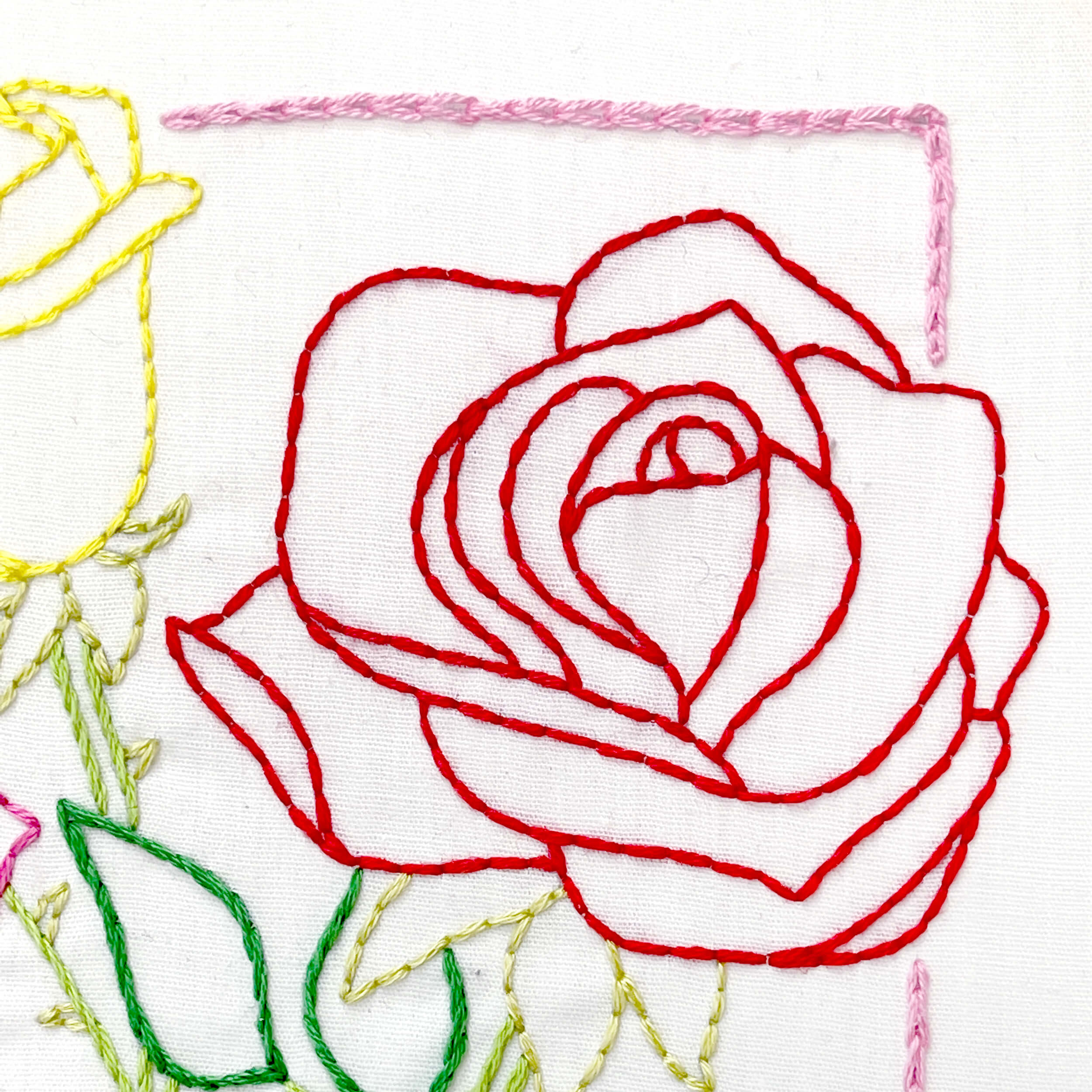 Close up of rose embroidery, back stitch, chain stitch, red rose
