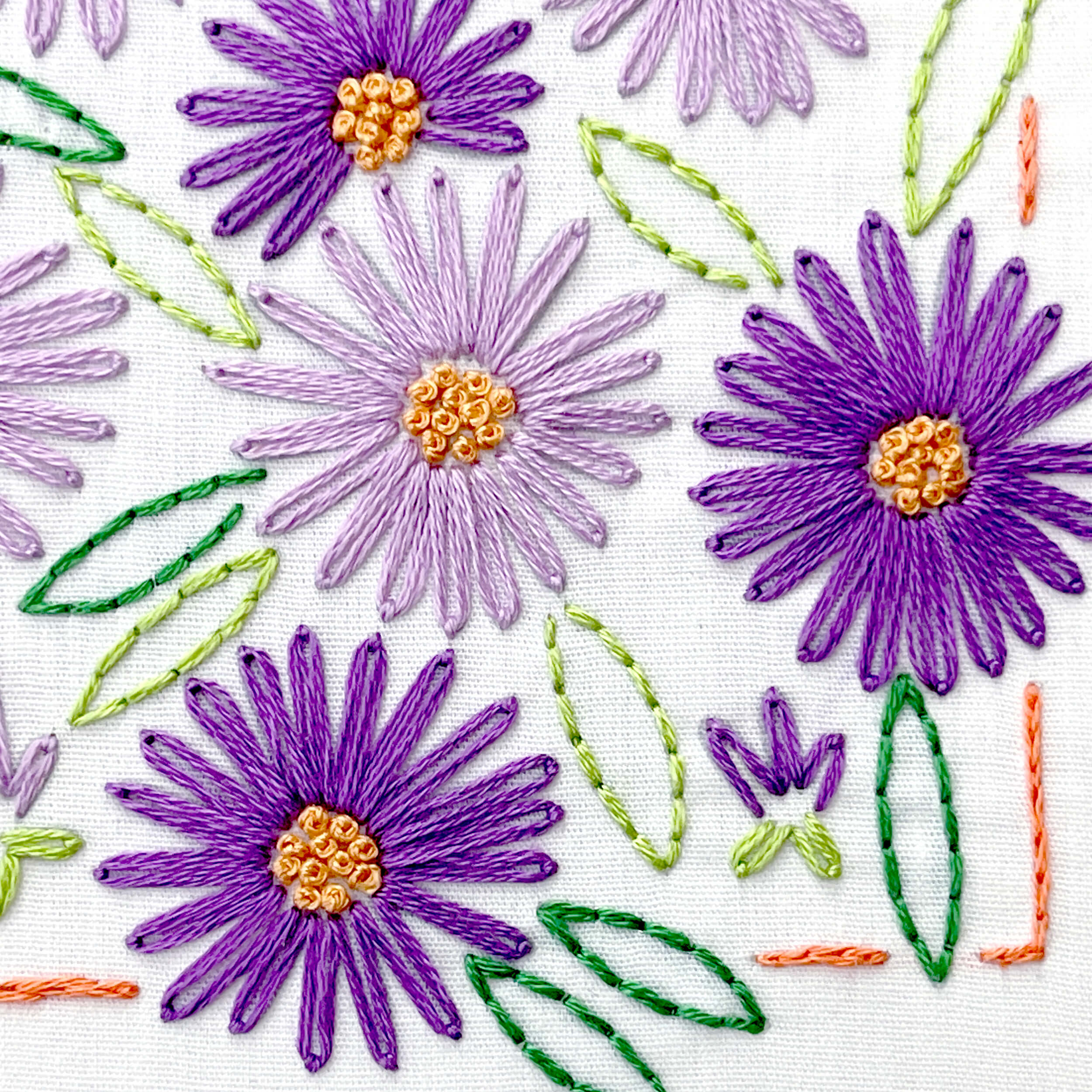 September Aster purple flower snd green leaves stitched with backstitch