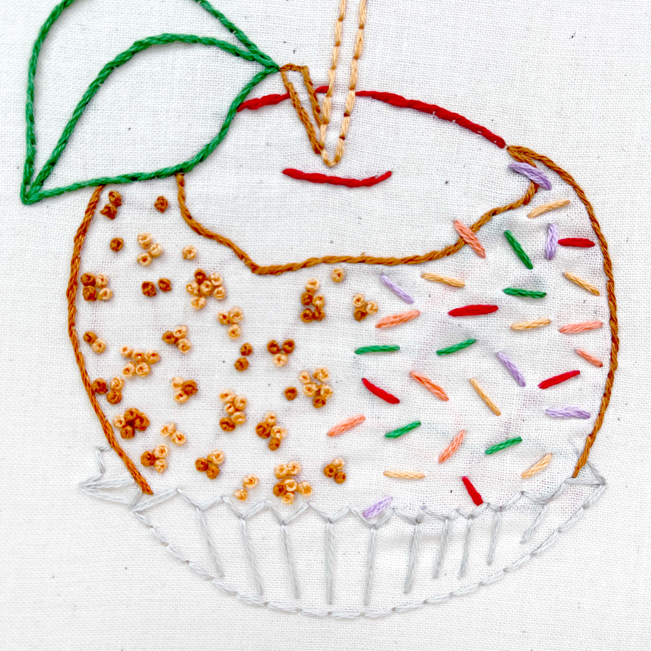 embroidered caramel apple in wrapper