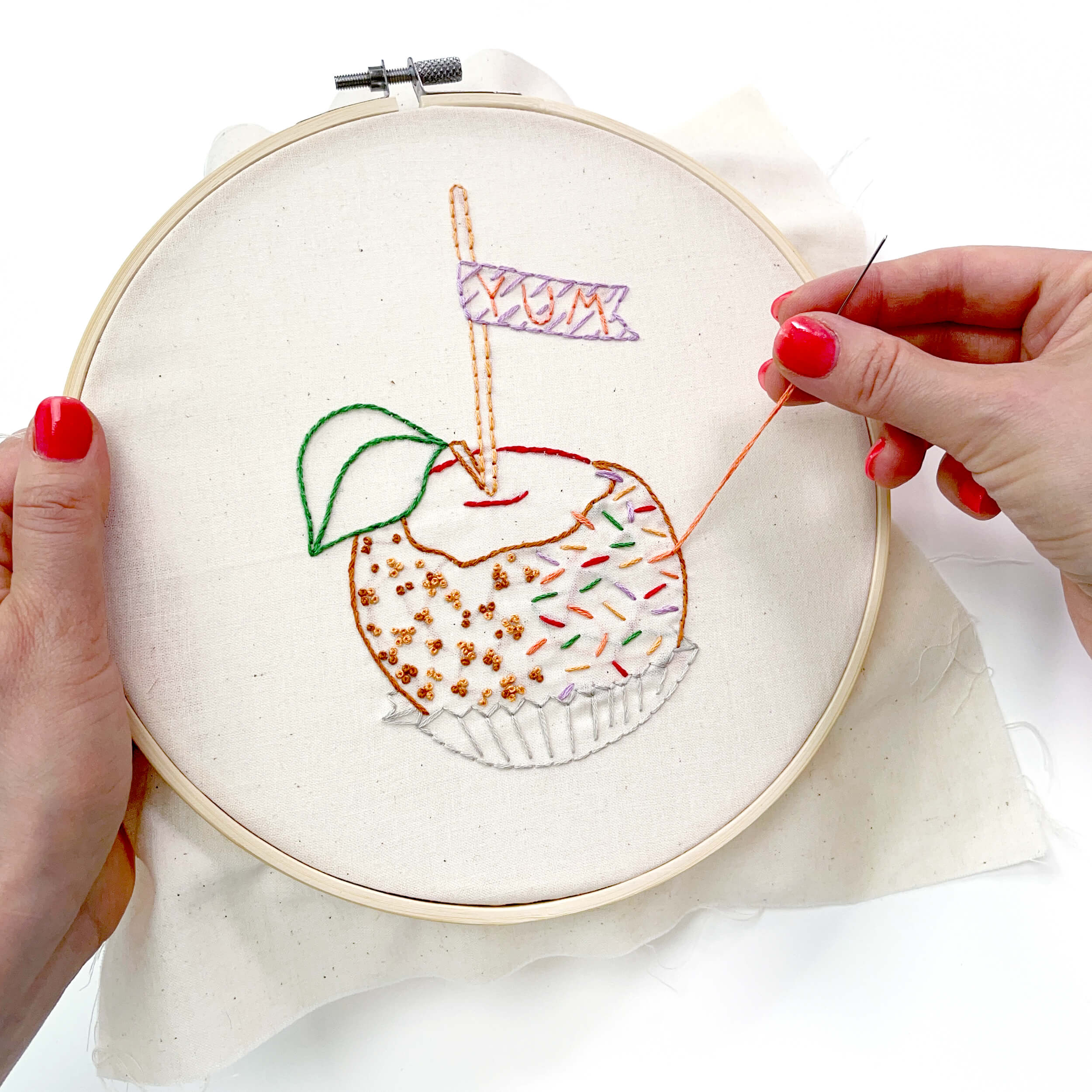 hand stitching the caramel apple with sprinkles and peanuts embroidery pattern