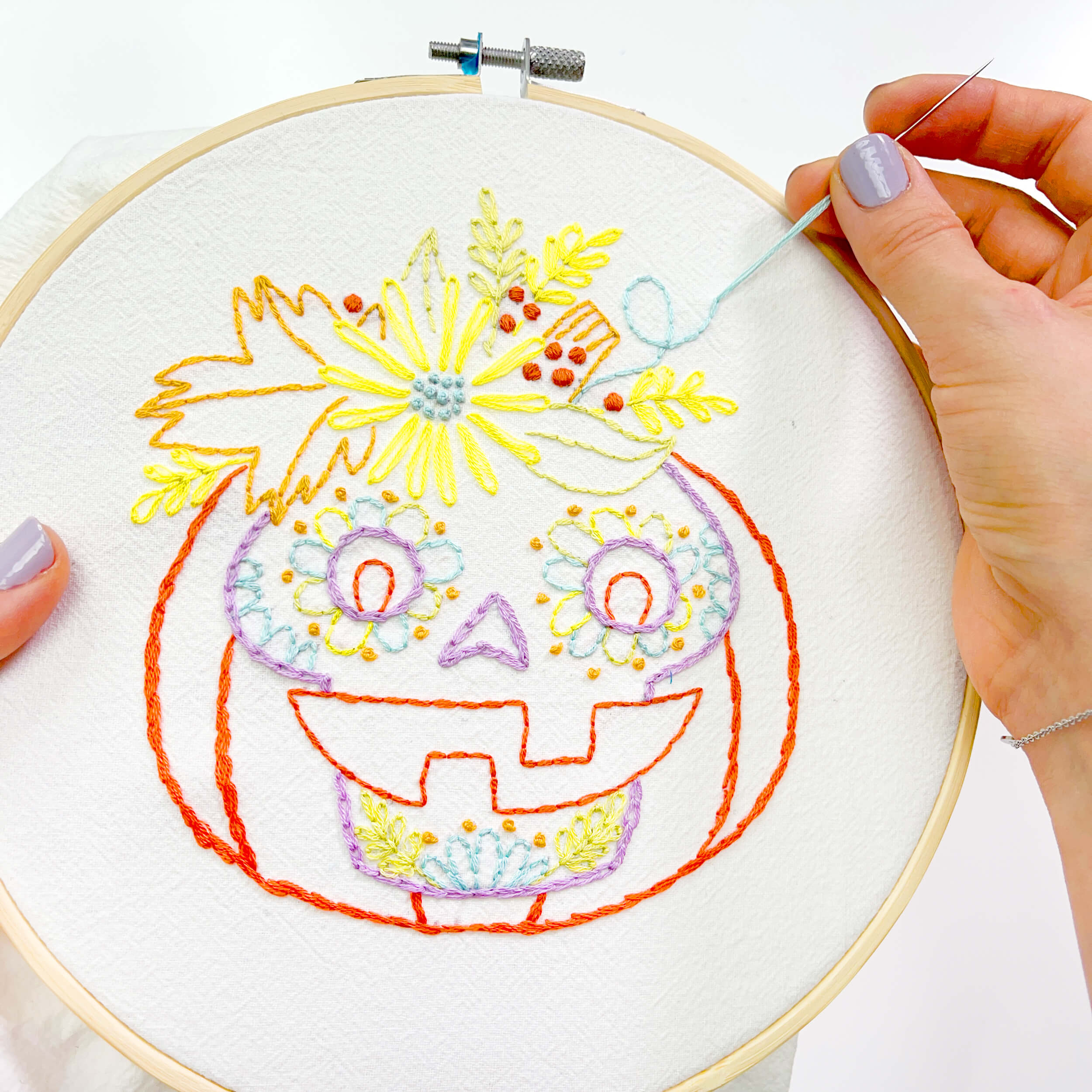 hand stitching the halloween sugar skull jack-o'-lantern embroidery pattern