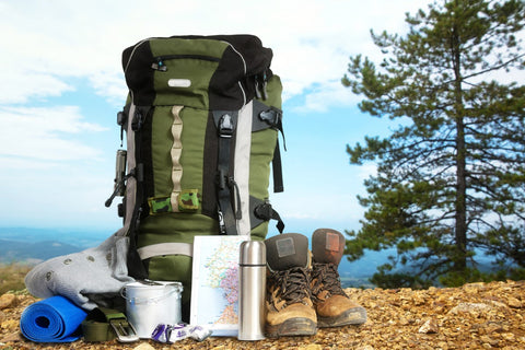 Camping-Ausrüstung mit Rucksack, Wanderschuhen und Zubehör