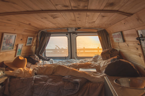 Wood paneled and comfortably decorated interior in a camper van