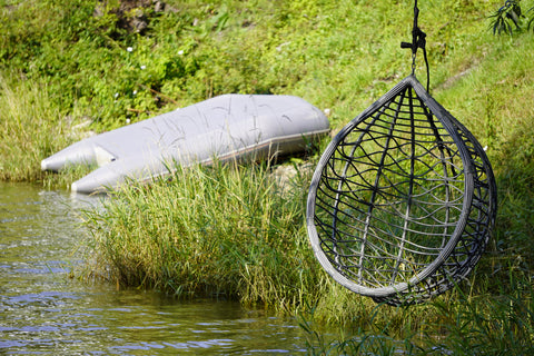 Hanging chair on a river bank