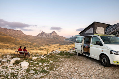Couple enjoying view with camper