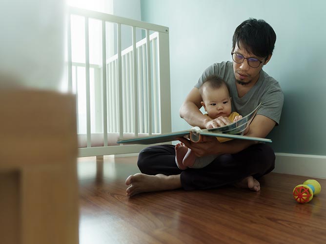 Father reading a bedtime story to his young child.