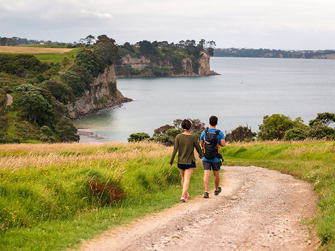 Babymoon destination of New Zealand, couple walking.