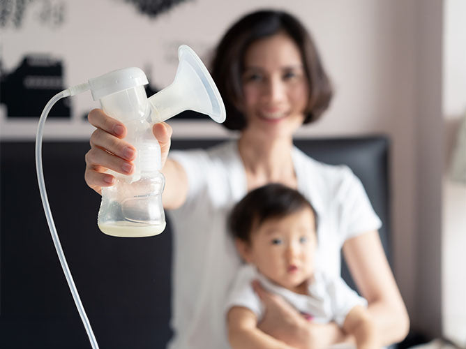 Closeup of a clean breast pump attached to a baby bottle.