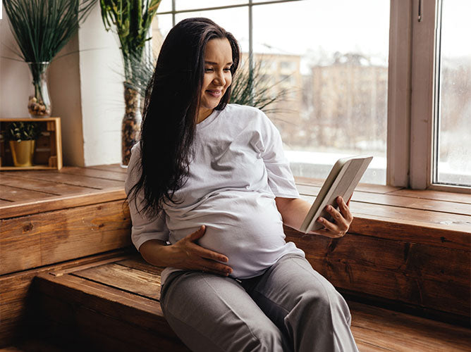 Pregnant woman on a virtual video call with a doula.