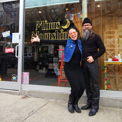 photo of owner and store manager in black clothing in front of storefront